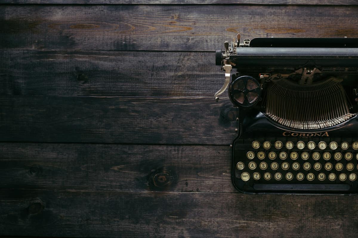 A vintage typewriter on a dark wooden desk